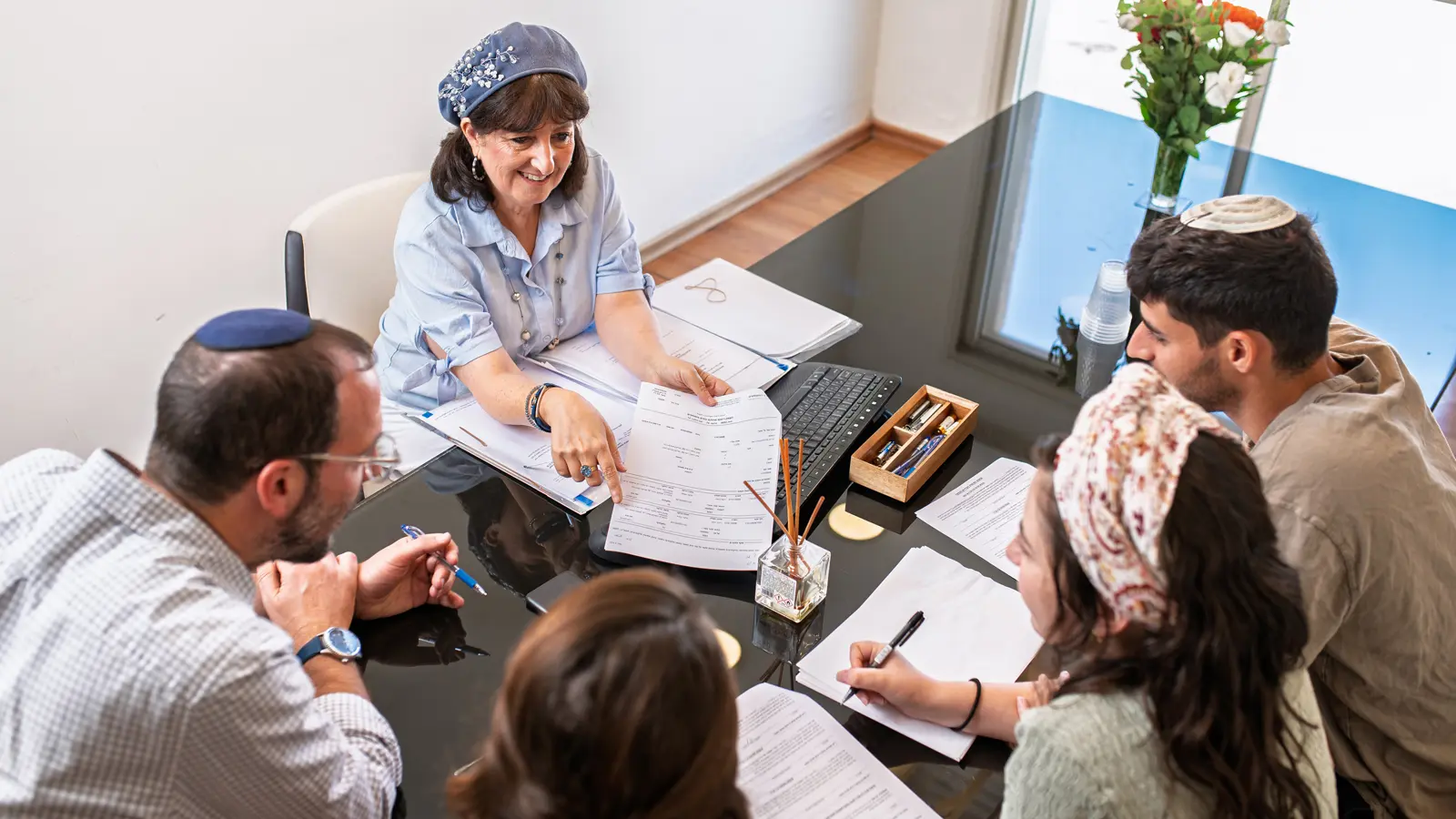 Two couples signing real estate contact with Rena Hollander